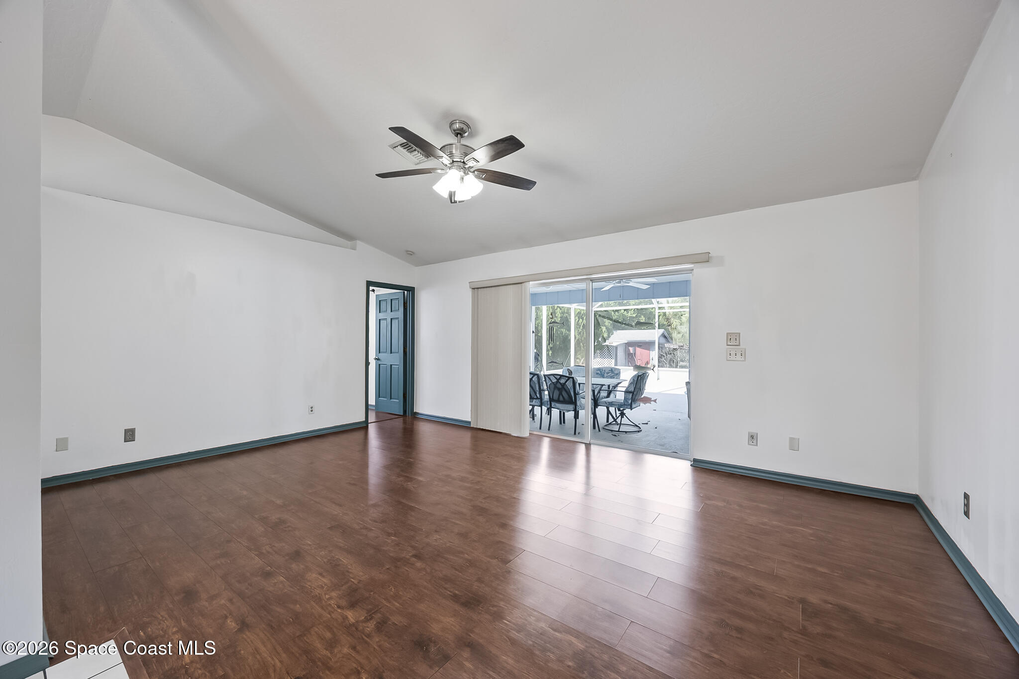 854 Dale Circle Sebastian, FL 32958 - Photo 6 of 31 a view of an empty room with wooden floor and a window