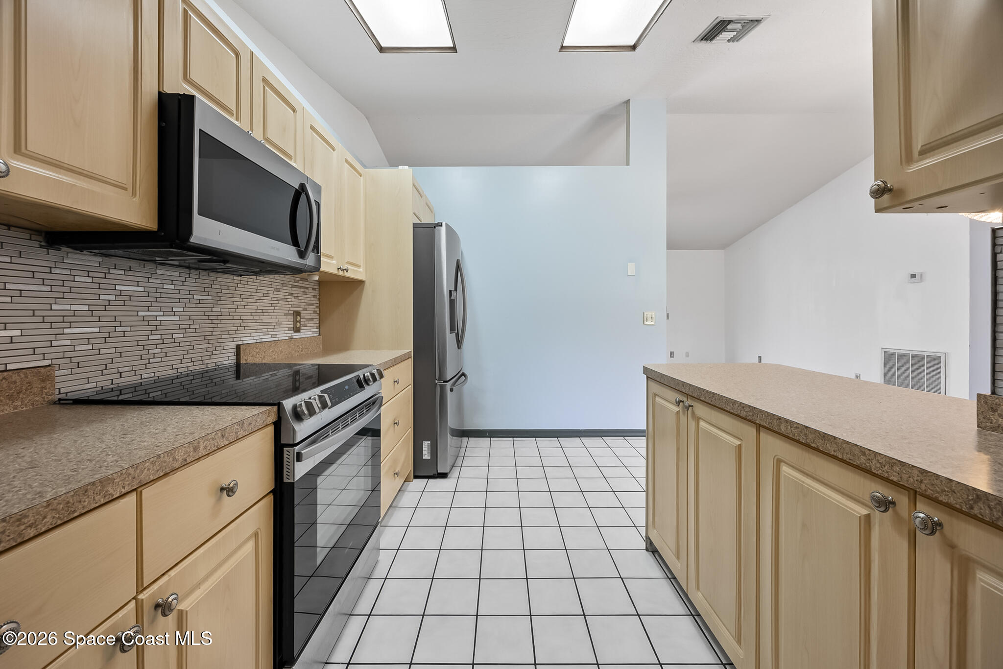 854 Dale Circle Sebastian, FL 32958 - Photo 8 of 31 a kitchen with granite countertop a sink a stove top oven a refrigerator and cabinets