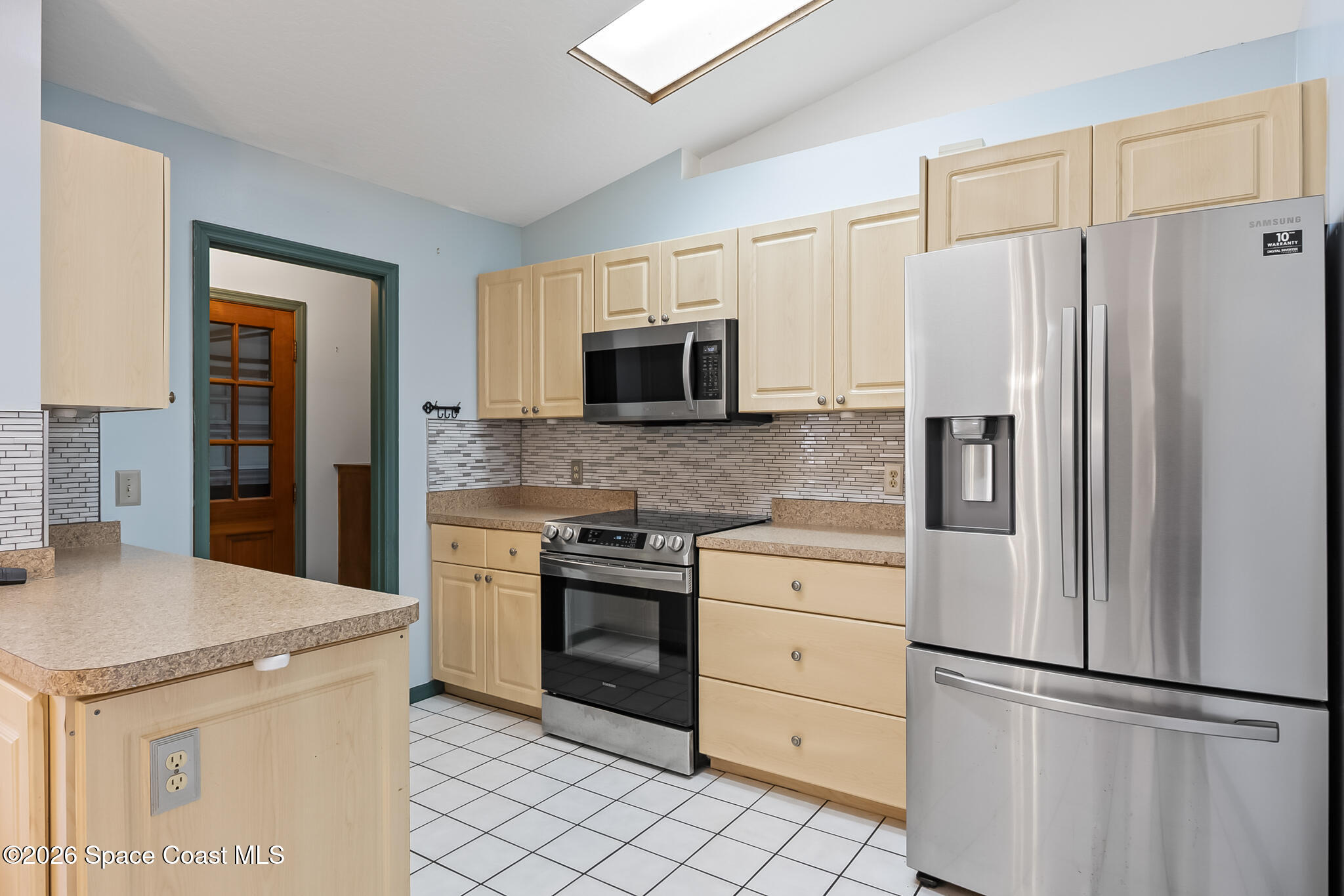 854 Dale Circle Sebastian, FL 32958 - Photo 9 of 31 a kitchen with white cabinets and stainless steel appliances