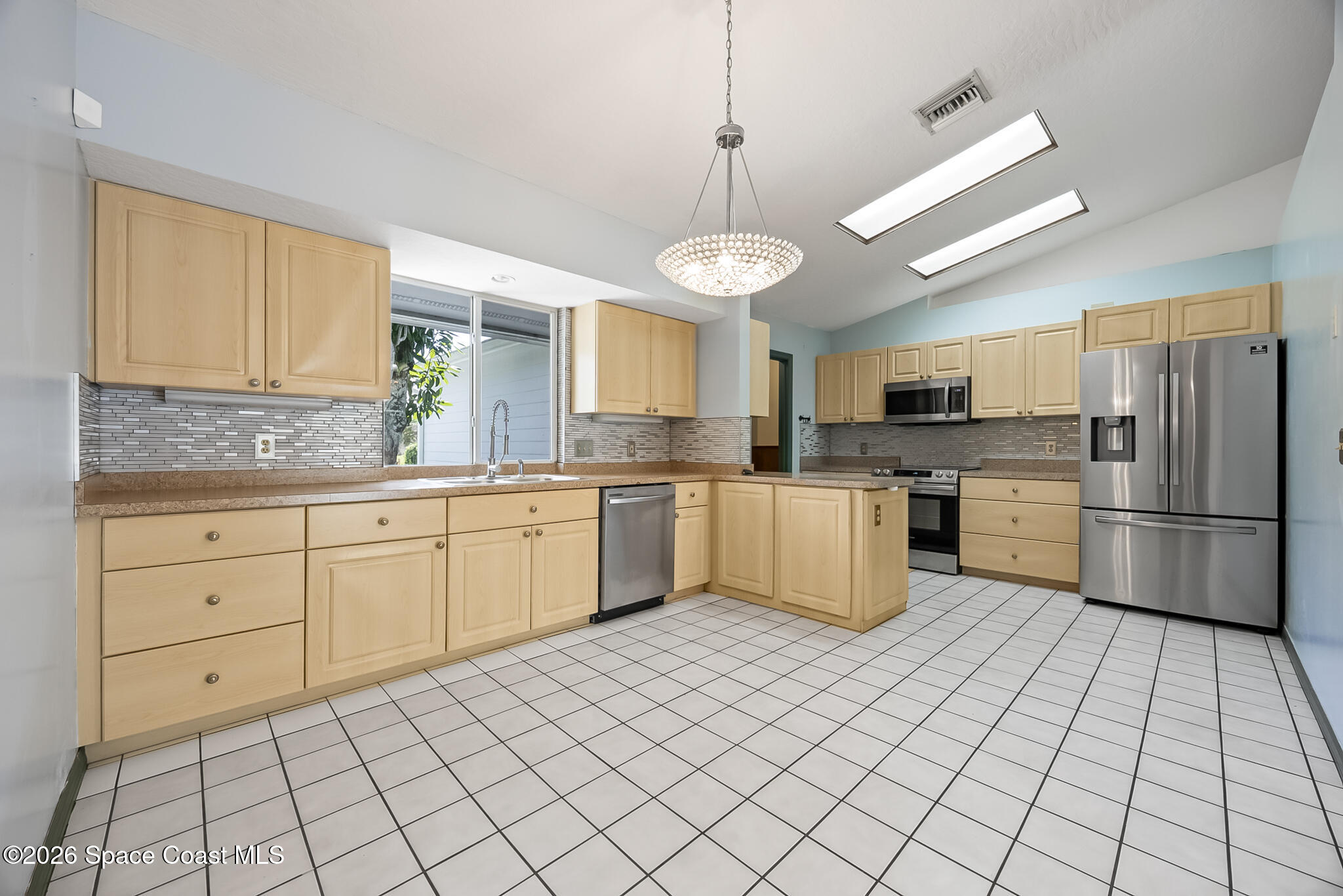 854 Dale Circle Sebastian, FL 32958 - Photo 10 of 31 a kitchen with a stove cabinets and refrigerator