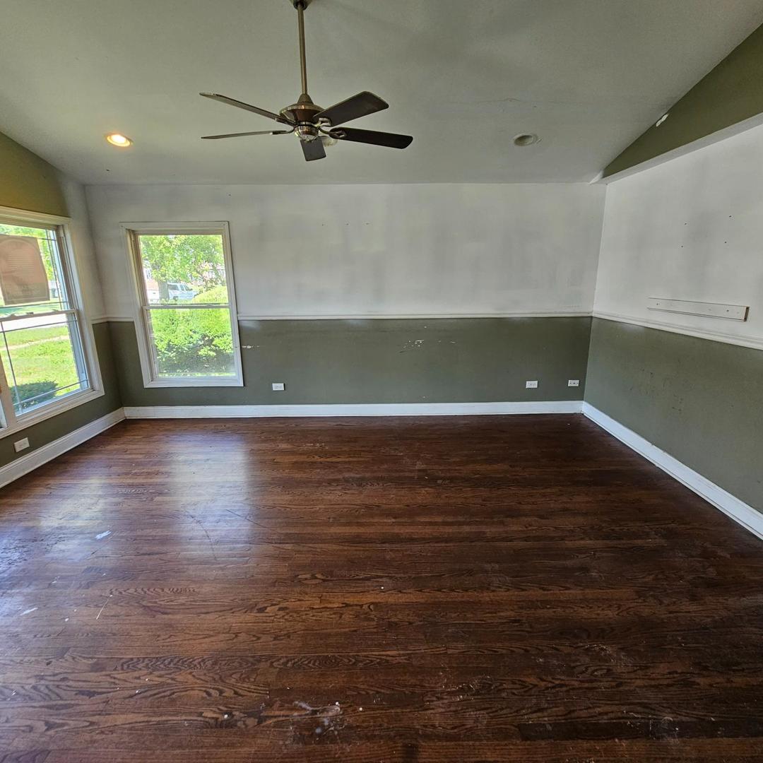 14237 Minerva Avenue Dolton, IL 60419 - Photo 4 of 17 an empty room with wooden floor fan and windows