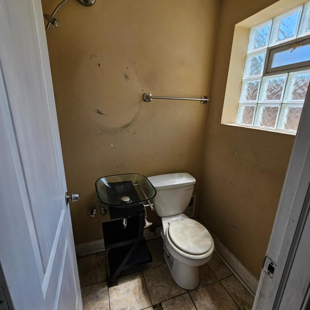 14237 Minerva Avenue Dolton, IL 60419 - Photo 8 of 17 a toilet sitting in a bathroom next to a sink