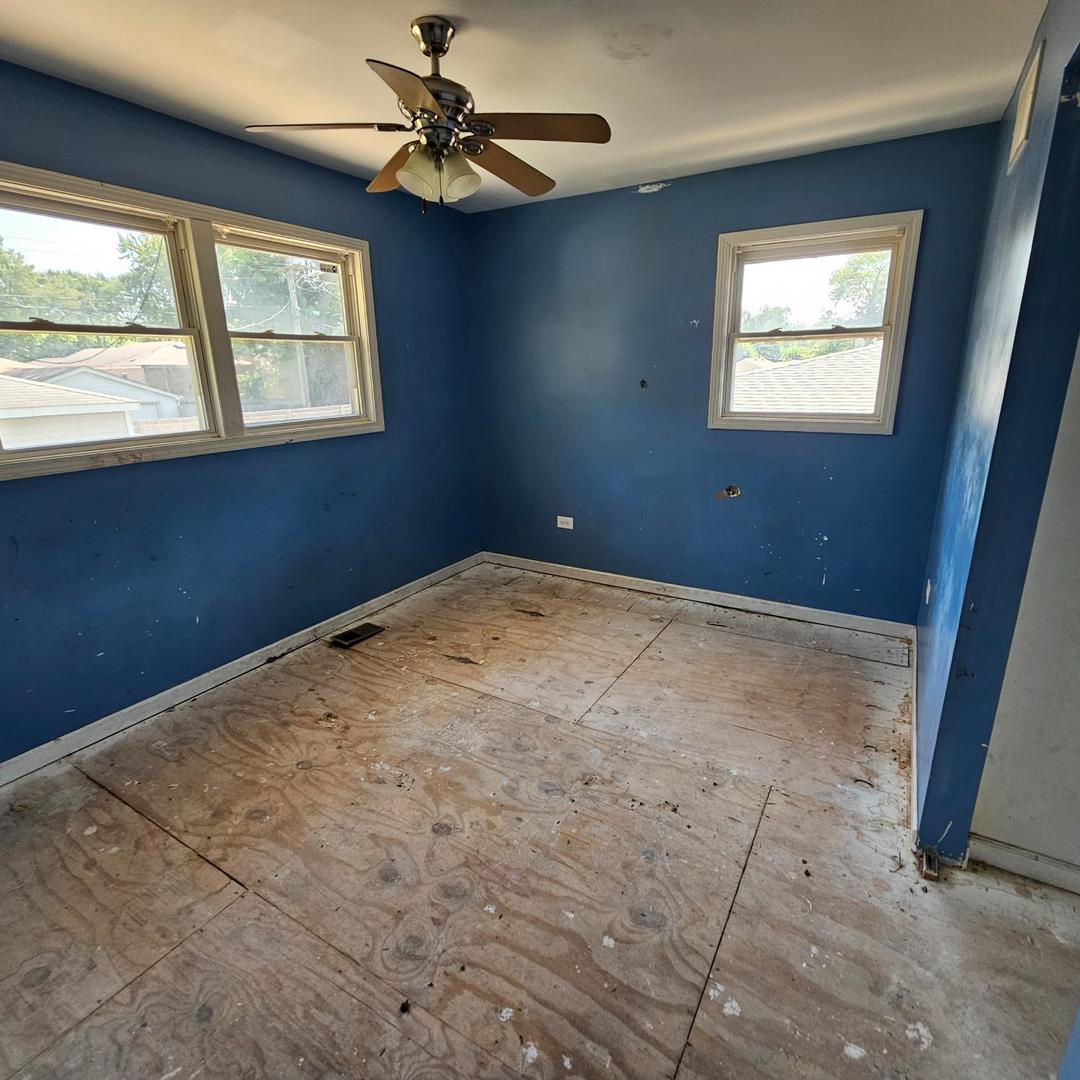 14237 Minerva Avenue Dolton, IL 60419 - Photo 10 of 17 an empty room with windows and fan