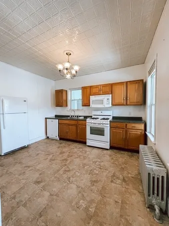 a kitchen with a cabinets and white stainless steel appliances