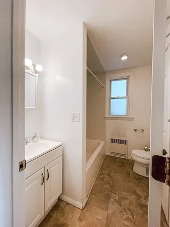a bathroom with a sink a toilet and vanity
