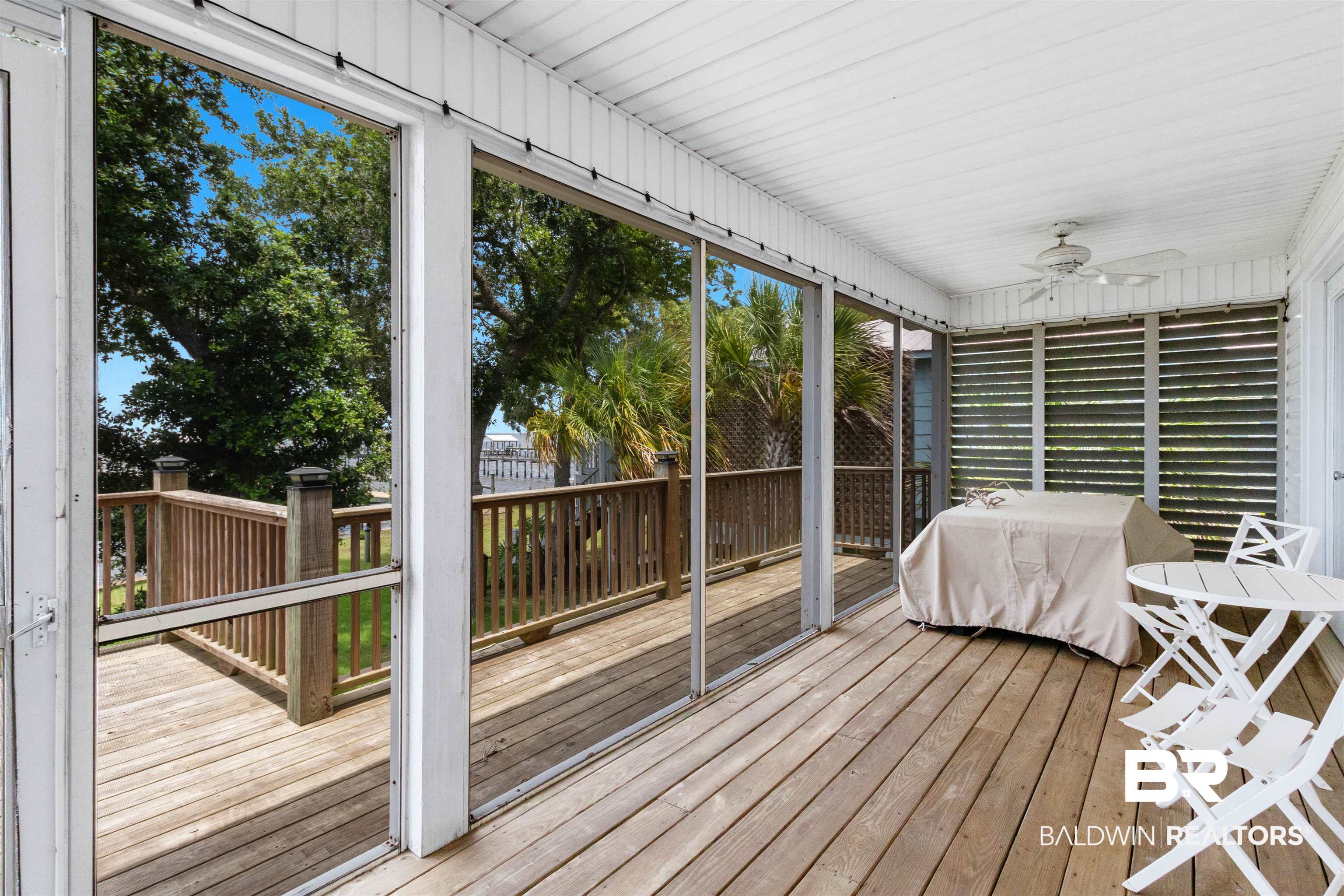 9581 South Bay Street Foley, AL 36535 - Photo 25 of 44 Screened porch featuring wood-finish flooring, a white paneled ceiling, and a ceiling fan with light fixture