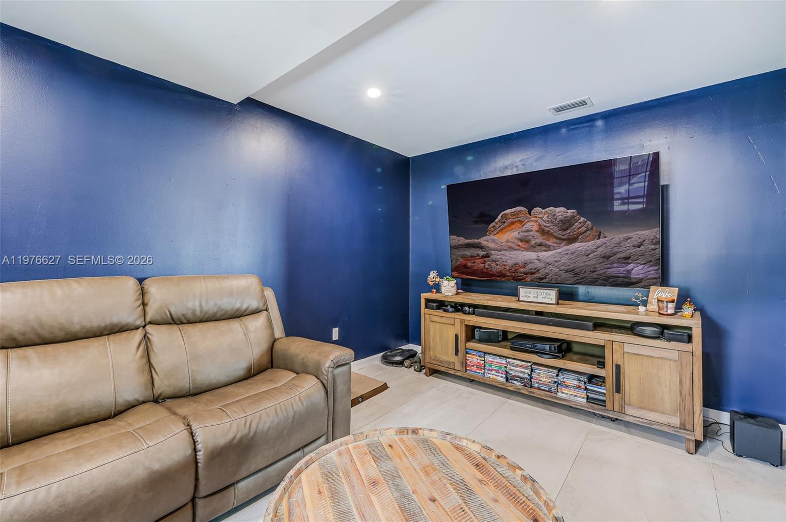 11747 Southwest 113th Terrace Miami, FL 33186 - Photo 11 of 46 a living room with furniture and a flat screen tv