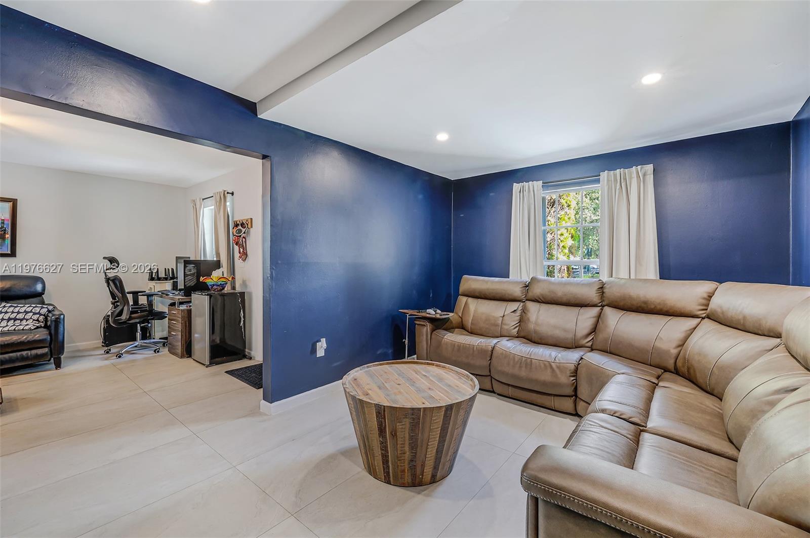 11747 Southwest 113th Terrace Miami, FL 33186 - Photo 12 of 46 a living room with furniture and a chair