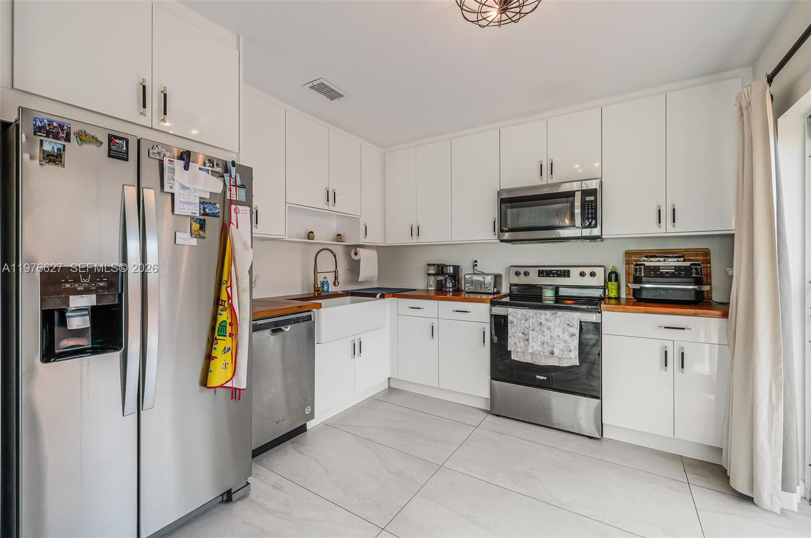 11747 Southwest 113th Terrace Miami, FL 33186 - Photo 17 of 46 a kitchen with stainless steel appliances a refrigerator sink and microwave
