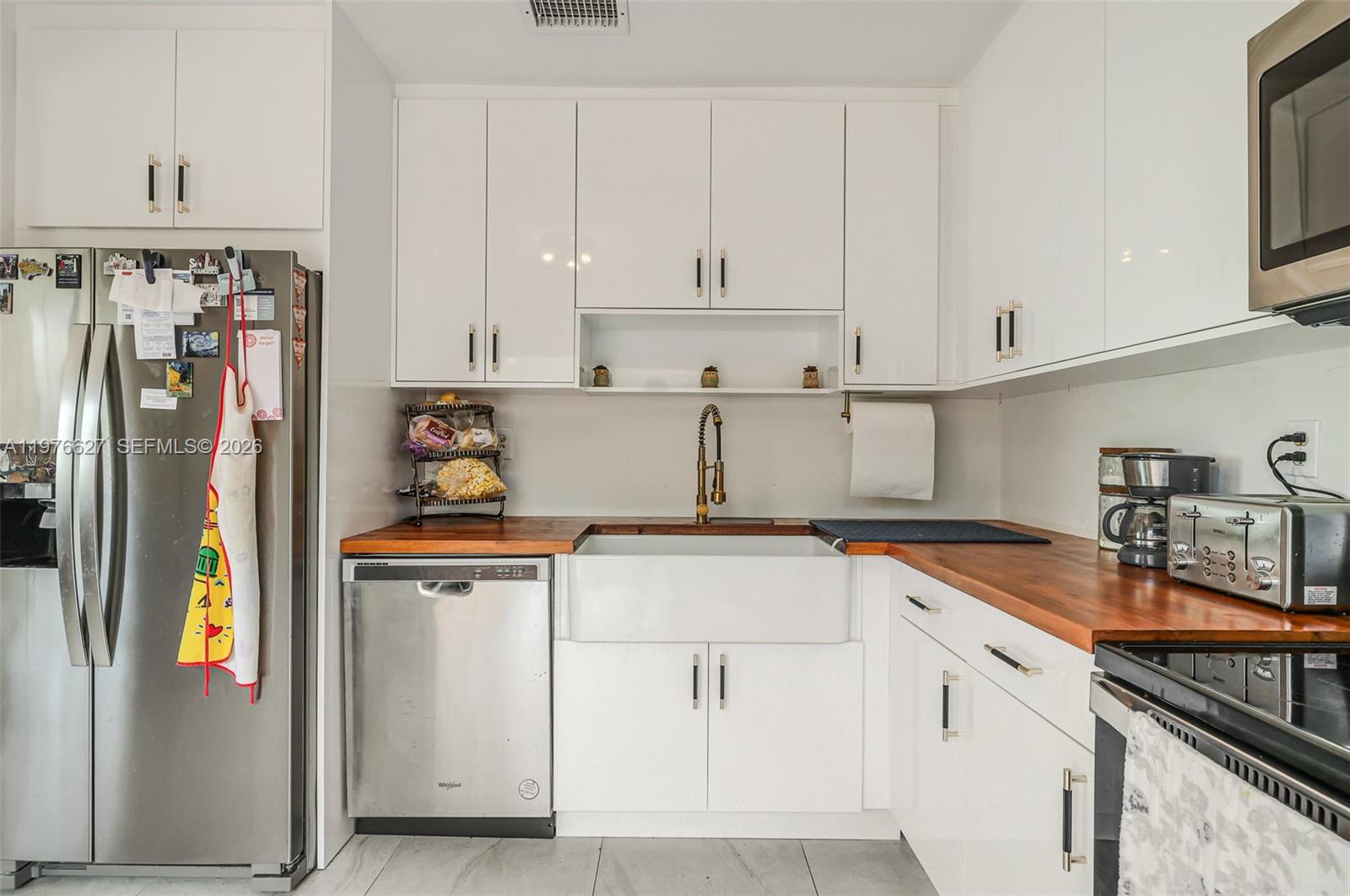 11747 Southwest 113th Terrace Miami, FL 33186 - Photo 18 of 46 a kitchen with stainless steel appliances granite countertop a refrigerator and a stove