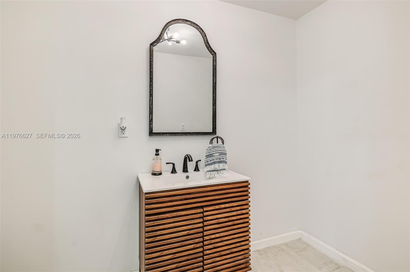 11747 Southwest 113th Terrace Miami, FL 33186 - Photo 19 of 46 a bathroom with a sink and a mirror
