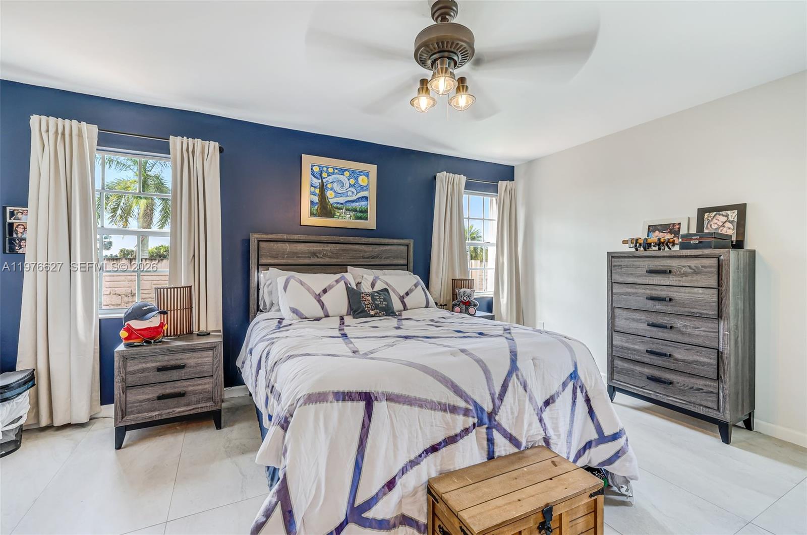 11747 Southwest 113th Terrace Miami, FL 33186 - Photo 21 of 46 a bedroom with a bed and a chandelier