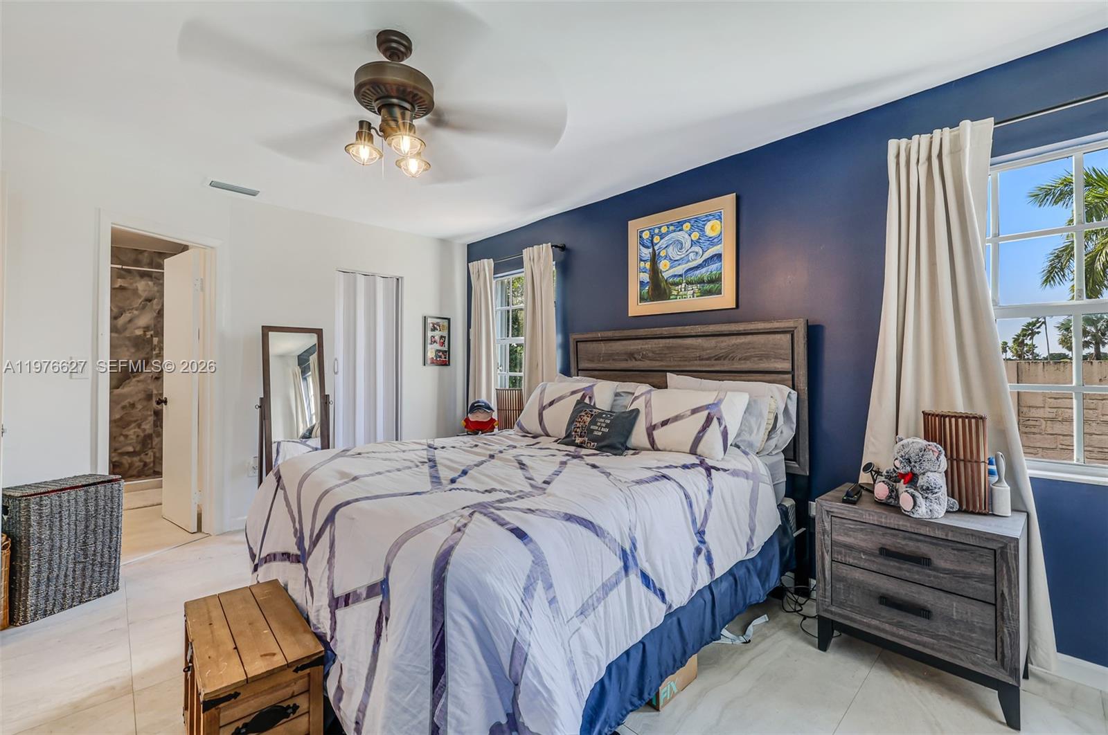 11747 Southwest 113th Terrace Miami, FL 33186 - Photo 22 of 46 a bedroom with a bed and a chandelier