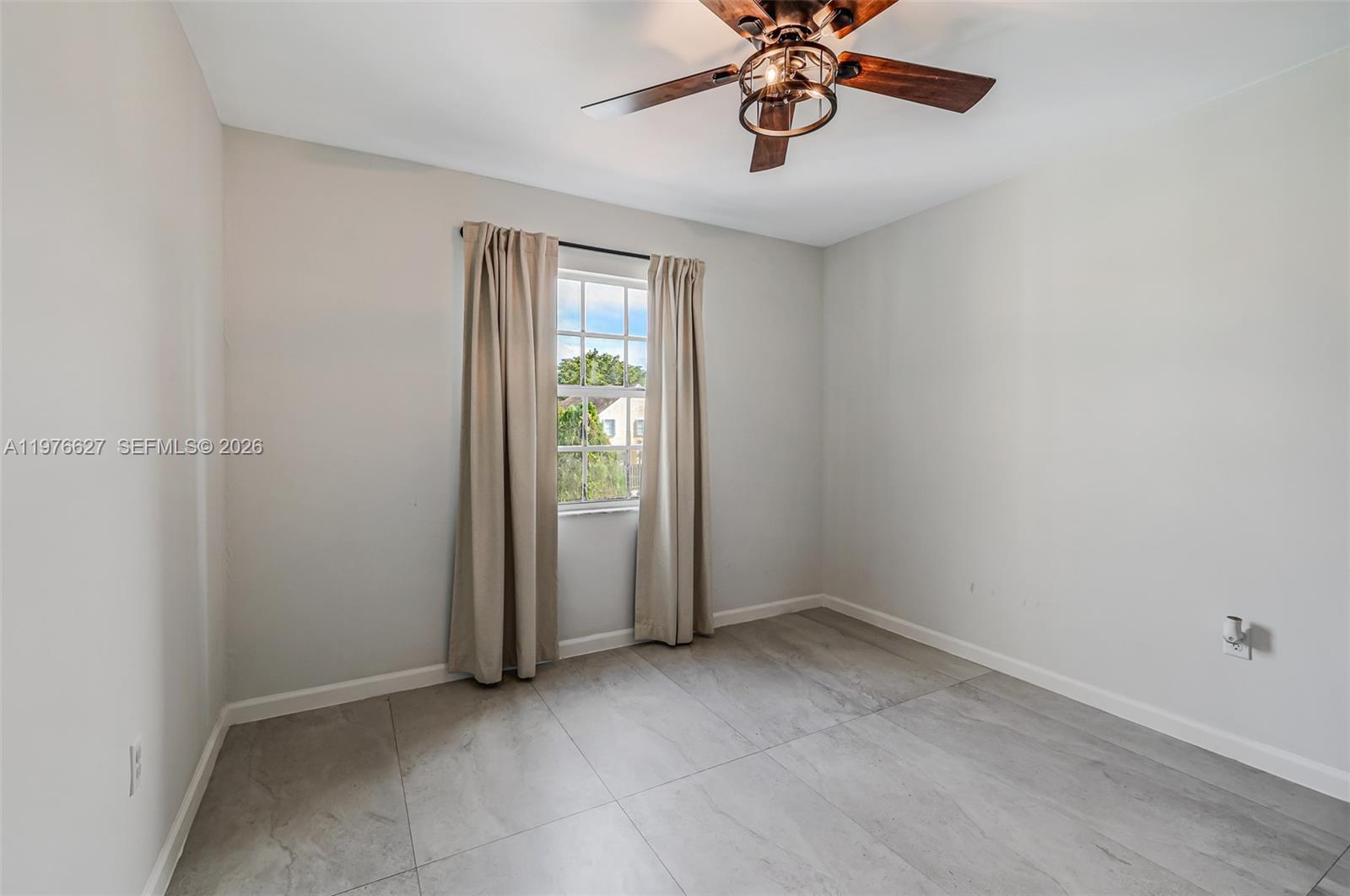 11747 Southwest 113th Terrace Miami, FL 33186 - Photo 25 of 46 an empty room with windows and chandelier fan