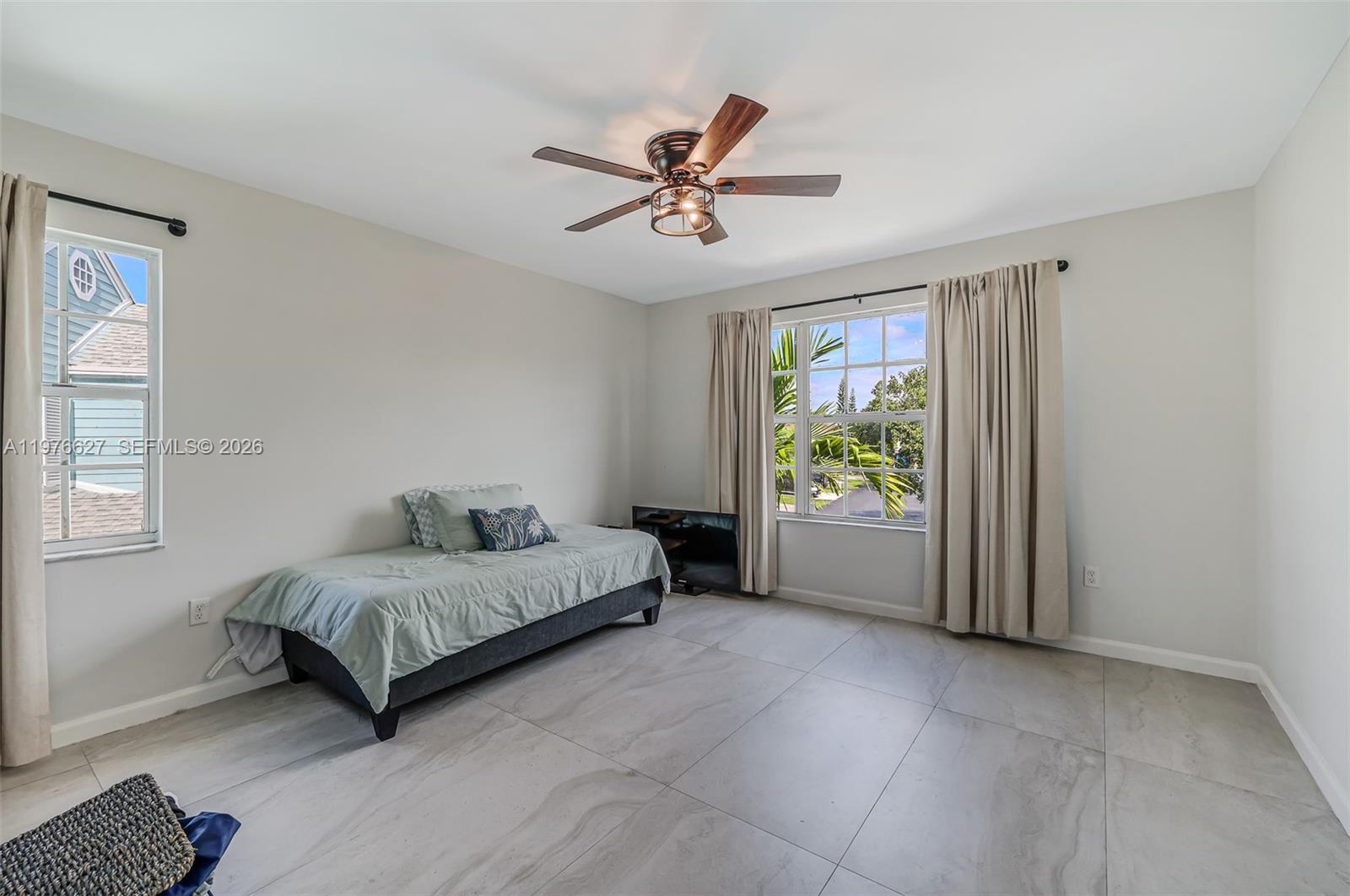 11747 Southwest 113th Terrace Miami, FL 33186 - Photo 27 of 46 a bedroom with a bed and a window