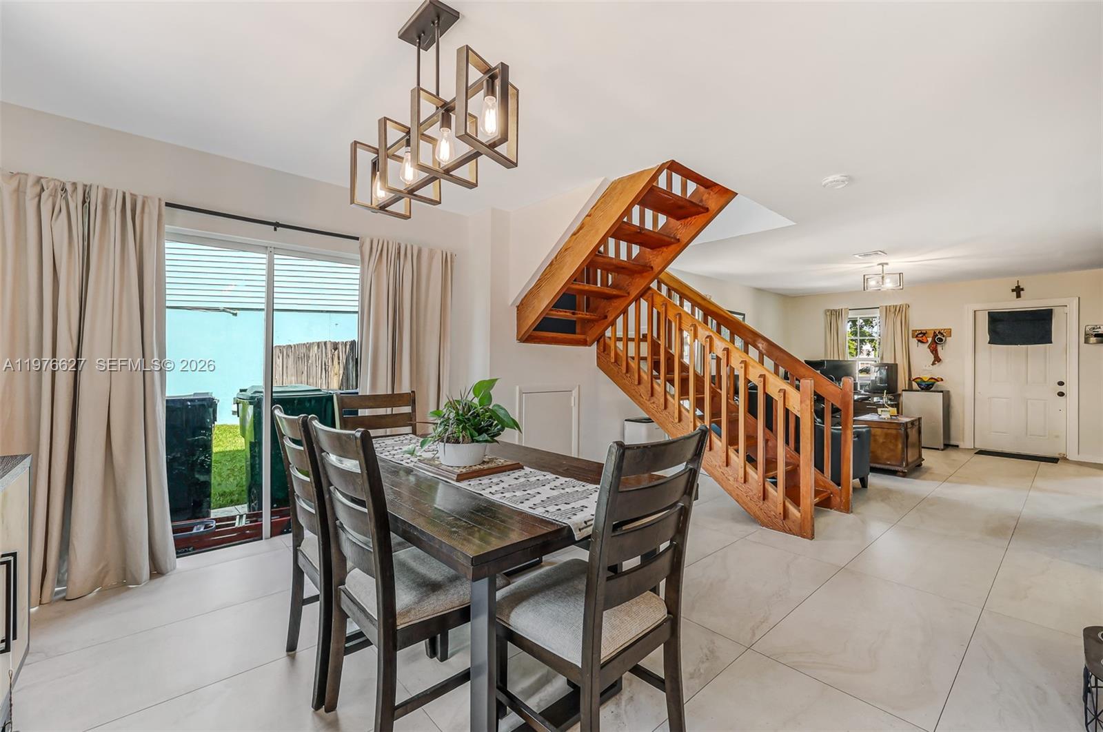 11747 Southwest 113th Terrace Miami, FL 33186 - Photo 40 of 46 a view of a dining room with furniture and a chandelier