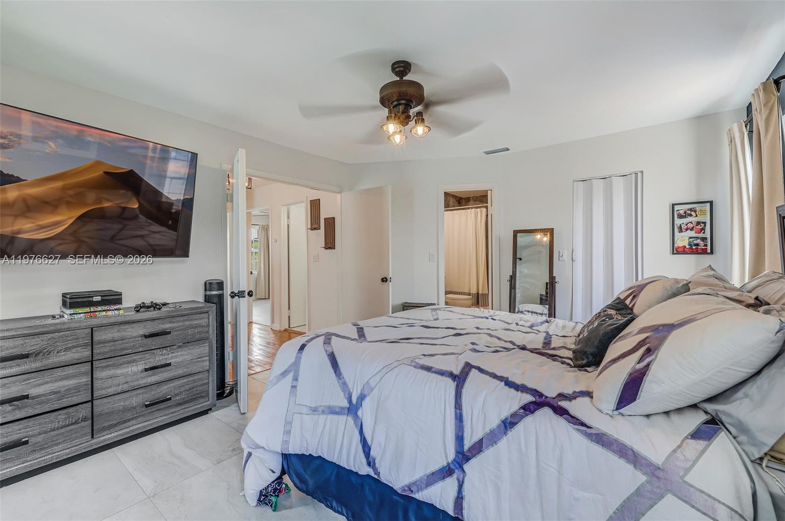 11747 Southwest 113th Terrace Miami, FL 33186 - Photo 41 of 46 a bedroom with a bed and a flat tv screen on dresser