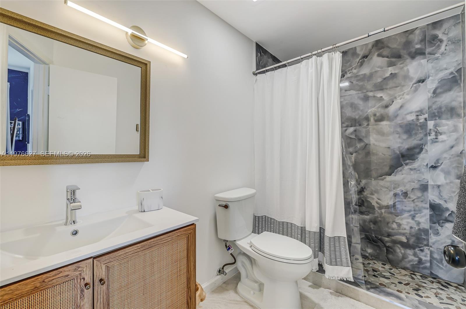 11747 Southwest 113th Terrace Miami, FL 33186 - Photo 42 of 46 a bathroom with a sink a toilet and shower