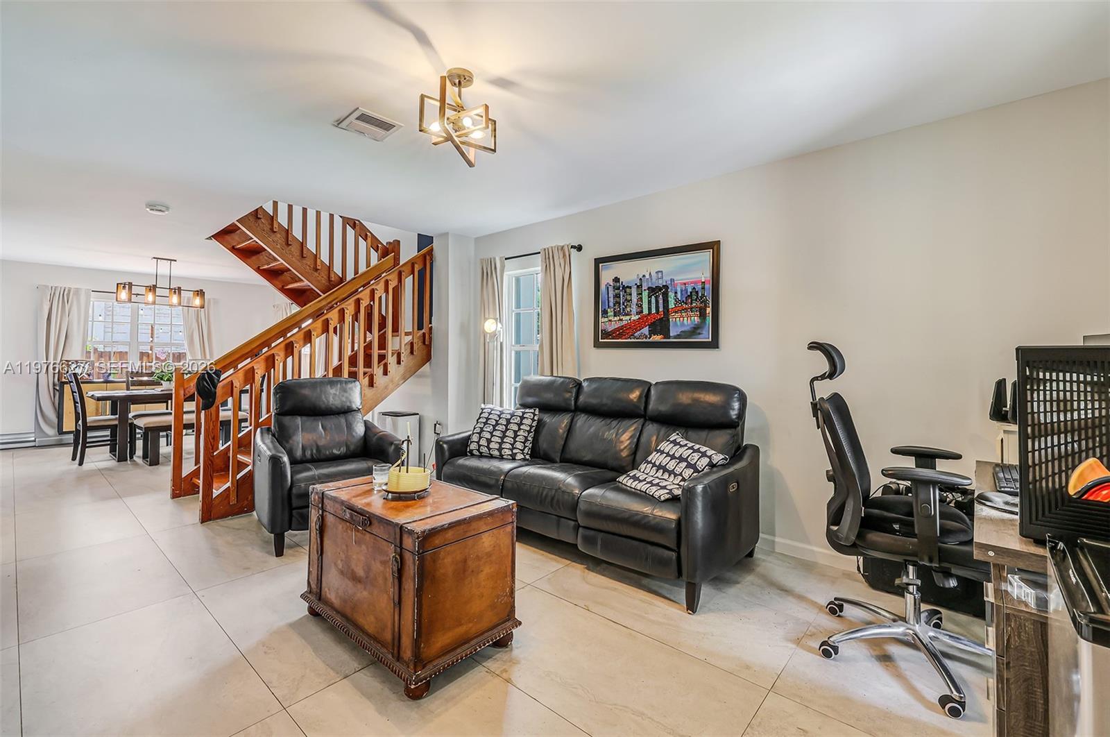 11747 Southwest 113th Terrace Miami, FL 33186 - Photo 5 of 46 a living room with furniture a piano and a bookshelf