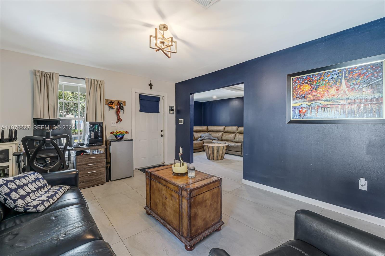 11747 Southwest 113th Terrace Miami, FL 33186 - Photo 7 of 46 a living room with furniture and a flat screen tv
