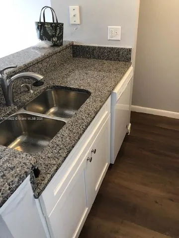 a kitchen with a sink and granite top