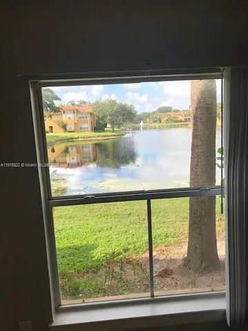 a view of a glass door with a lake view