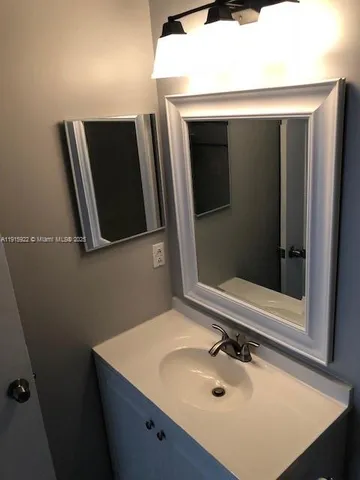 a bathroom with a sink and mirror