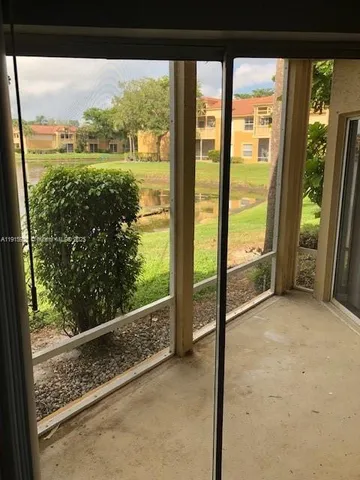 a view of a glass door and wooden floor