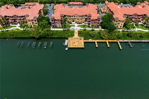 an aerial view of a house with a garden and lake view