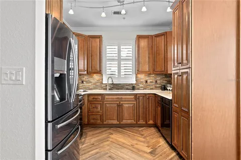 a kitchen with stainless steel appliances a stove a sink and a microwave