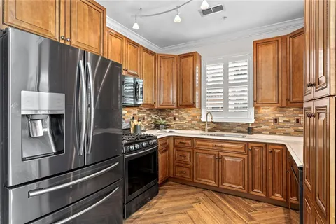 a kitchen with stainless steel appliances a sink and a window