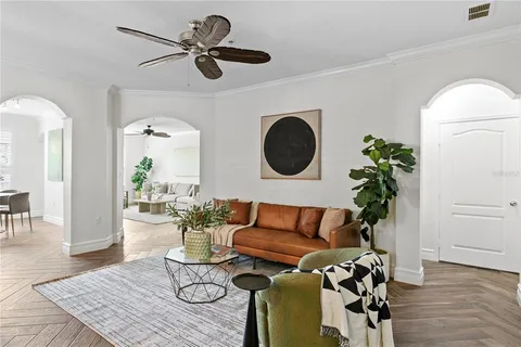 a living room with furniture dining table and a potted plant