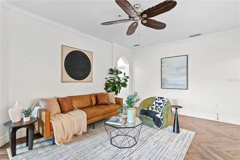 a living room with furniture and a potted plant