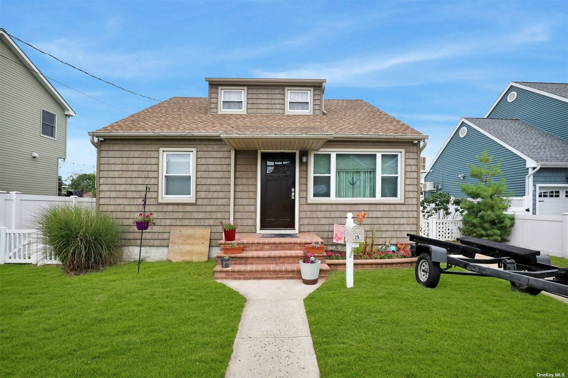 25 Jackson Place Massapequa, NY 11758 - Photo 1 of 1 a front view of house with yard and outdoor seating