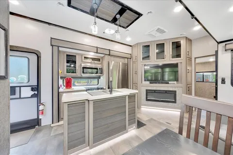 a view of kitchen with cabinets and refrigerator