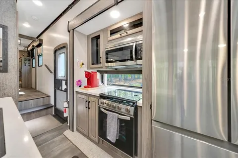 a kitchen with stainless steel appliances granite countertop a stove and a refrigerator