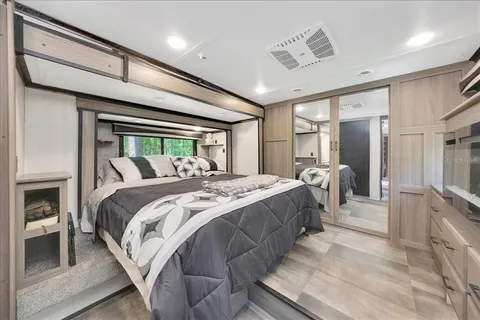 a spacious bedroom with a bed and a walk in closet