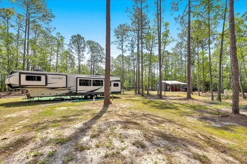 a view of a house with swimming pool and sitting area