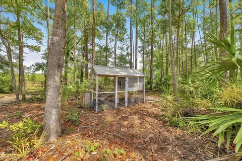a backyard of a house with table and chairs