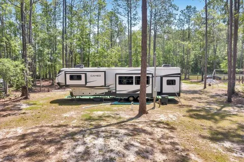 a view of a house with swimming pool and sitting area