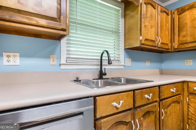 a kitchen with stainless steel appliances granite countertop a sink and a window