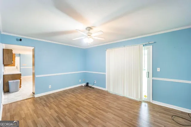 wooden floor in an empty room with a window
