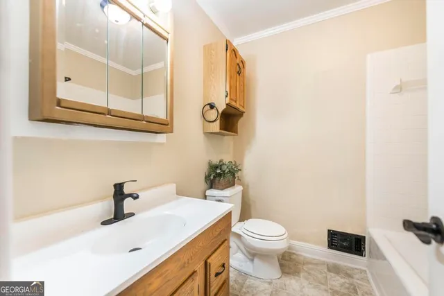 a bathroom with a sink a toilet and mirror