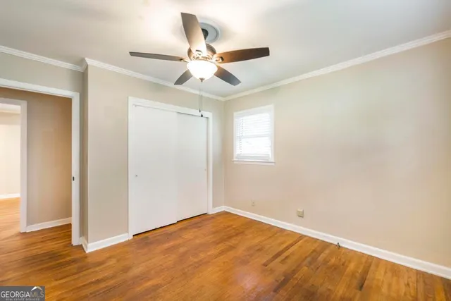 a view of an empty room and wooden floor