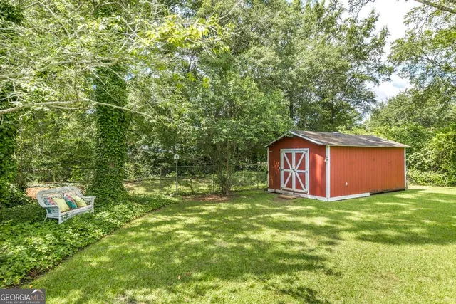 a view of a backyard with large trees