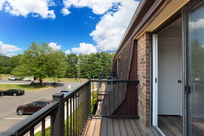 504 Nottingham Way, Unit 504 Flemington, NJ 08822 - Photo 11 of 12 a view of balcony with wooden floor and fence