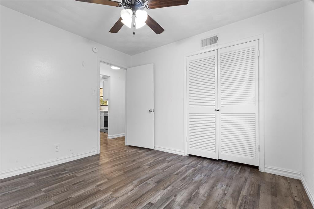 1809 Balla Way Grand Prairie, TX 75051 - Photo 22 of 26 an empty room with wooden floor closet and windows