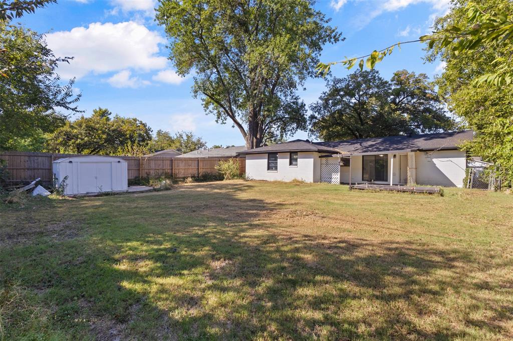 1809 Balla Way Grand Prairie, TX 75051 - Photo 26 of 26 a front view of house with yard and trees in the background
