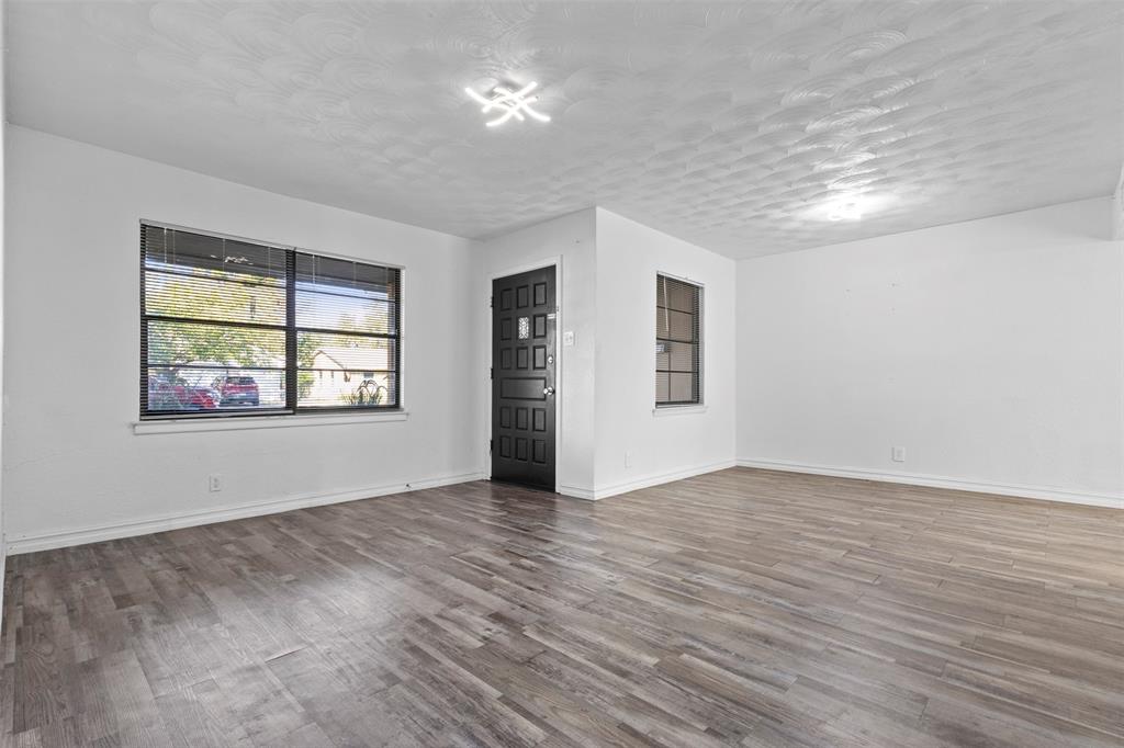 1809 Balla Way Grand Prairie, TX 75051 - Photo 4 of 26 an empty room with wooden floor and windows
