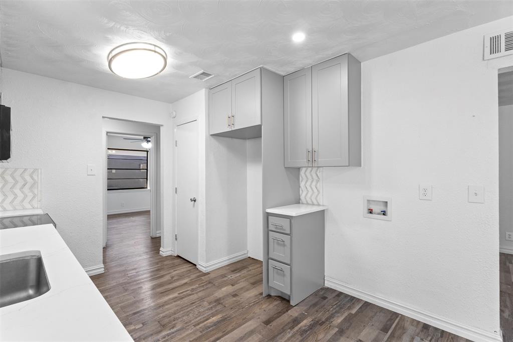 1809 Balla Way Grand Prairie, TX 75051 - Photo 10 of 26 a view of a kitchen with wooden floor and electronic appliances